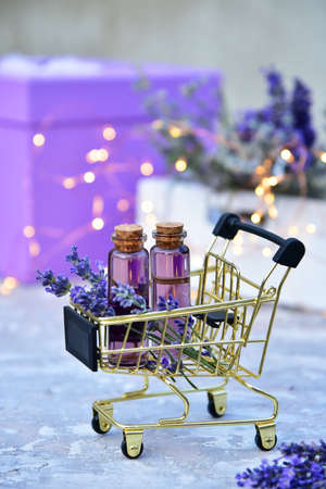 Lavender oil and lavender flowers on bokeh background.の写真素材
