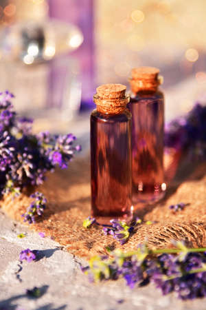Lavender oil and lavender flowers on bokeh background.の写真素材
