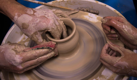 Master teaches apprentice potteryの写真素材