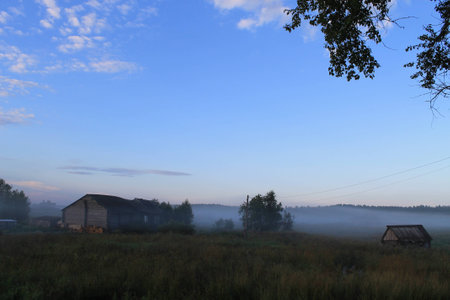misty landscape with farmhousesの写真素材
