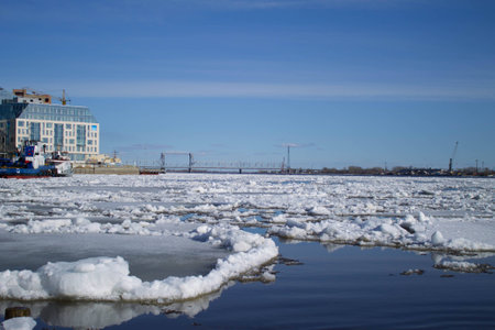 Ice drift on the river in the spring in the northern city