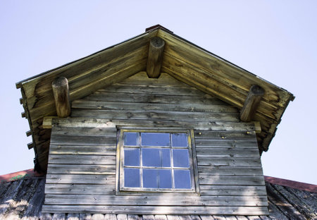 The unusual roof of the old rural wooden houseの写真素材