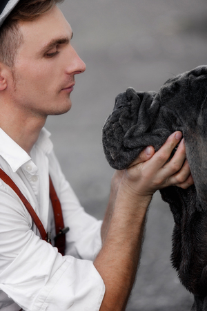 Portrait of a young man with a dog.の写真素材