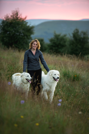 beautiful women and two white dogs morema stand on grassの写真素材