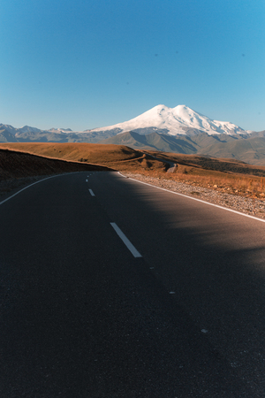 road to cool mountain with ice hat . mount elbrusの写真素材