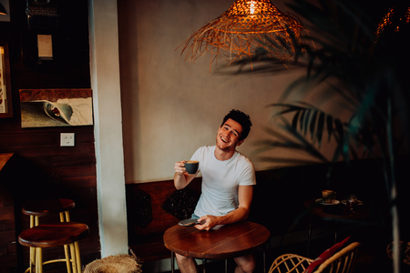 Handsome confident guy man smiling and posing on camera, Man dress in white t-shortの写真素材