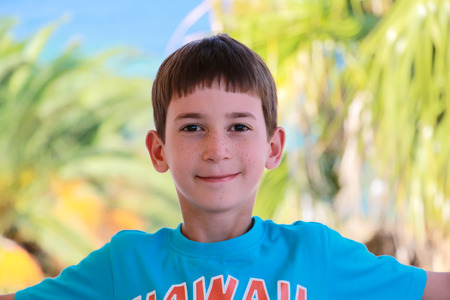 Smiling boy with freckles on his faceの写真素材