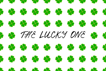 Saint Patrick's Day greeting card with green mosaic clover leaves and text on white background. Inscription - The lucky one! vector illustration.のイラスト素材