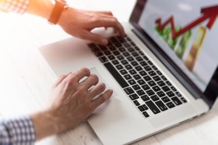 Young businessman using his laptop, close up. Business workplace and business objects.Freelancer work at homeの写真素材