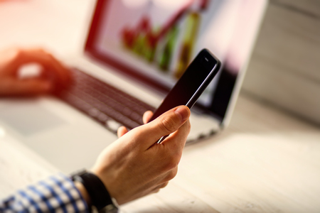 Young businessman using his laptop, close up. Business workplace and business objects.Freelancer work at homeの写真素材