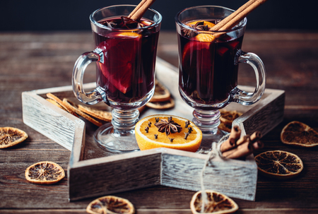 Christmas hot mulled wine in a glass with spices and citrus fruit. Mulled wine with cinnamon, anise and orangeの写真素材