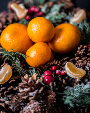 Tangerines with christmas decoration on rustic wooden background. Tangerines with spruce. Christmas decoration. Copy spaceの写真素材