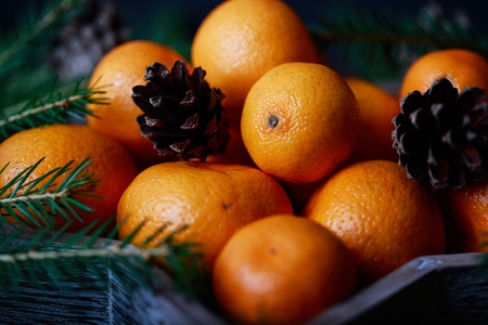 Tangerines with christmas decoration on rustic wooden background. Tangerines with spruce. Christmas decoration. Copy spaceの写真素材