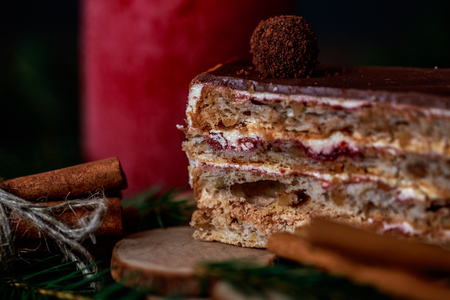 Christmas tasty cake on a dark wooden background with spruce decoration.