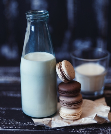 Colorful macaroons on a dark wooden background. Sweet macarons.の写真素材