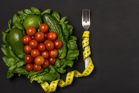 Healthy eating, dieting, slimming and weight loss concept. Fruits and vegetables on rustic wooden back with space for text. Diet conceptの写真素材