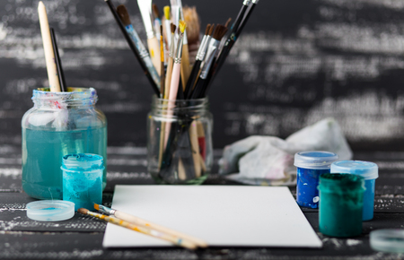 Art and craft tools.Artist's brush, canvas. Wooden art palette with tubes of acrylic paints.Artist's workshop.Art picture with copy space and for add text.Artist workplace background.Paints brushesの写真素材