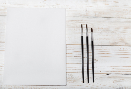 Art and craft tools.Artist's brush, canvas. Wooden art palette with tubes of acrylic paints.Artist's workshop.Art picture with copy space and for add text.Artist workplace background.Paints brushesの写真素材