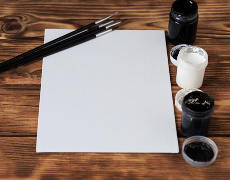 Artist's workshop. Canvas, paint, brushes, palette knife lying on the table.Art tools.Artist workplace background.Acrylic paint and brushes.Art picture with copy space and for add text.の写真素材