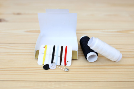 Colored threads on a wooden background. Sewing kit. Set for needlework