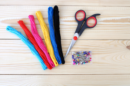 Colored threads on a wooden background. Sewing kit. Set for needlework