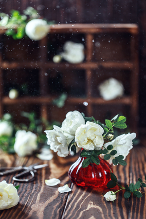 Bouquet of roses in a vase on a wooden rustic background. Flower compositionの写真素材