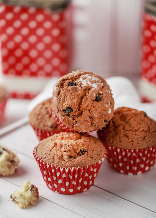 Fresh homemade delicious muffins with raisins on white background.の写真素材