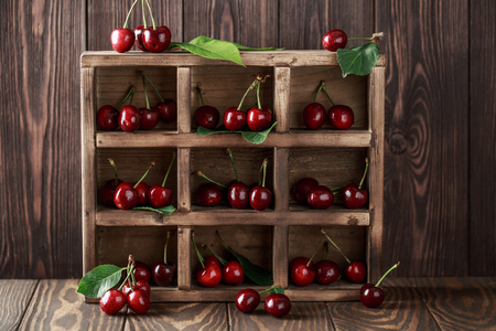 Fresh cherry with water drops on rustic wooden background. Fresh cherries background. Healthy food conceptの写真素材