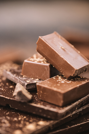 Chocolate bar pieces. Background with chocolate. Sweet food photo concept. The chunks of the broken chocolateの写真素材