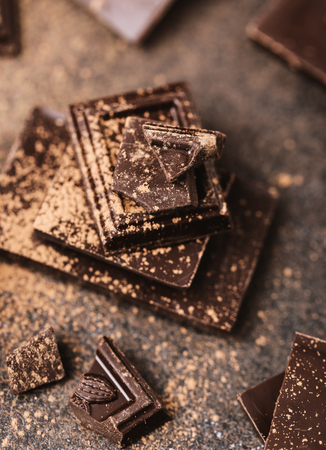 Chocolate bar pieces. Background with chocolate. Sweet food photo concept. The chunks of the broken chocolateの写真素材