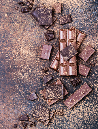 Chocolate bar pieces. Background with chocolate. Sweet food photo concept. The chunks of the broken chocolateの写真素材