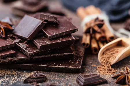 Chocolate bar pieces. Background with chocolate. Sweet food photo concept. The chunks of the broken chocolateの写真素材