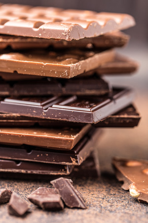Chocolate bar pieces. Background with chocolate. Sweet food photo concept. The chunks of the broken chocolateの写真素材