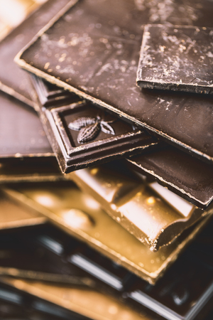 Chocolate bar pieces. Background with chocolate. Sweet food photo concept. The chunks of the broken chocolateの写真素材