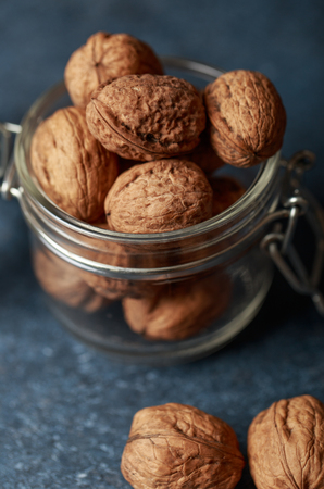 Walnuts. Walnut kernels and whole walnuts on rustic table.