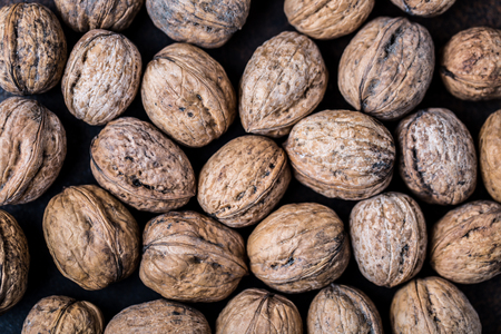 Walnuts. Walnut kernels and whole walnuts on rustic table.の写真素材