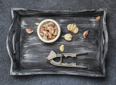 Fresh garlic with chili pepper and rosemary on wooden background. Garlic bulbsの写真素材
