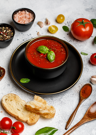 Traditional Spanish cold tomato soup gazpacho in a bowl on stone background. Traditional Spanish food. Concept cold rolled soup made of ripe tomatoes. Copy space, closeupの写真素材