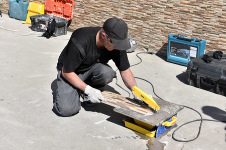 Construction worker facing the house with facing tileの写真素材
