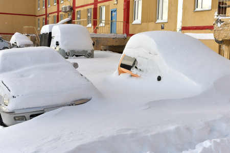 Cars buried in snowdrift after the blizzardの写真素材
