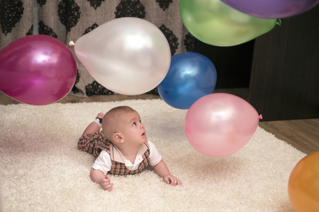 Little baby looking at the flying balloonsの写真素材