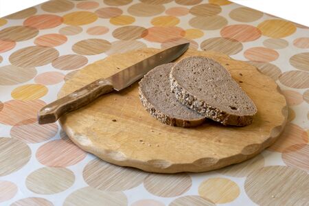 Brown grain bread on the wooden cutboardの写真素材