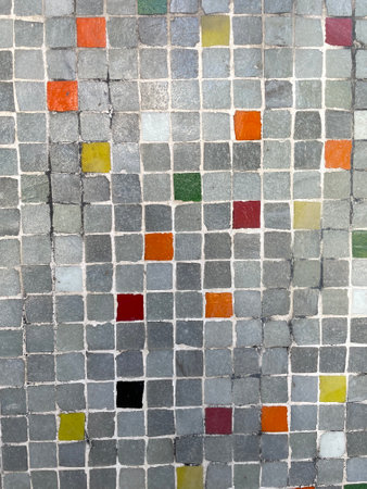 tile texture with small squares of gray yellow and red colorsの写真素材