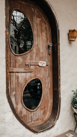 A beautifully rustic wooden door that features unique and charming oval windows, enhancing any entrances characterの写真素材