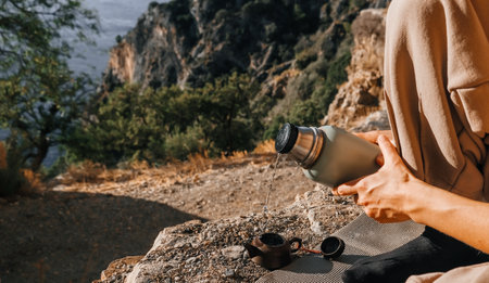 A serene and peaceful moment spent in the embrace of nature, accompanied by a thermos, ideal for all adventure loversの写真素材