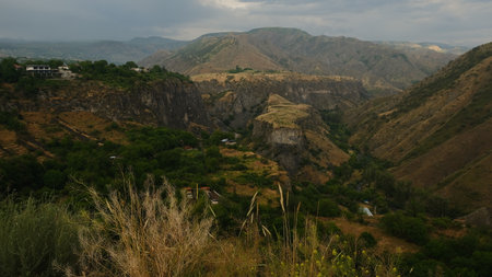 Mountain landscape near Garni Temple in Armenia with yellow-green grasses, slopes, plateaus and soft sunset lightの写真素材