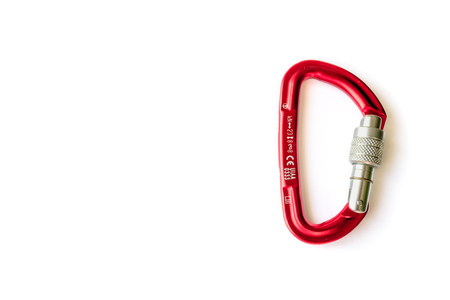 Red locking karabiner done up, isolated on white background, with copy space. Close up of locking carabiner. Basic climbing gear.の写真素材