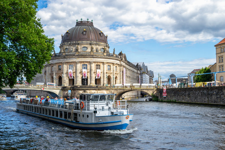Berlin / Germany - 1 July 2018: Tourist boat passing in front of Bode Museum, on Spree river. Located on Museum Island, the museum was designed by architect Ernst von Ihne and completed in 1904.のeditorial素材