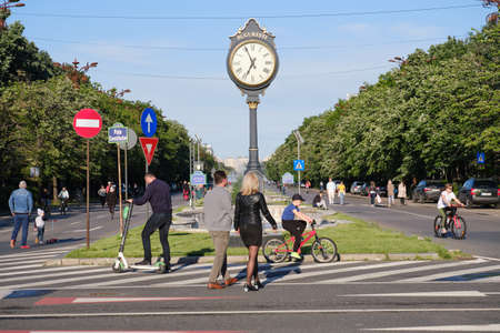 Pedestrians and cyclists in a car free zone during weekends at Bulevardul Unirii street near Constitution Square in Bucharest, Romania - May 30, 2020.のeditorial素材