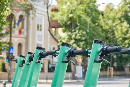 Row of green-blue electric scooters, a cleaner, modern alternative transportation option in cities....